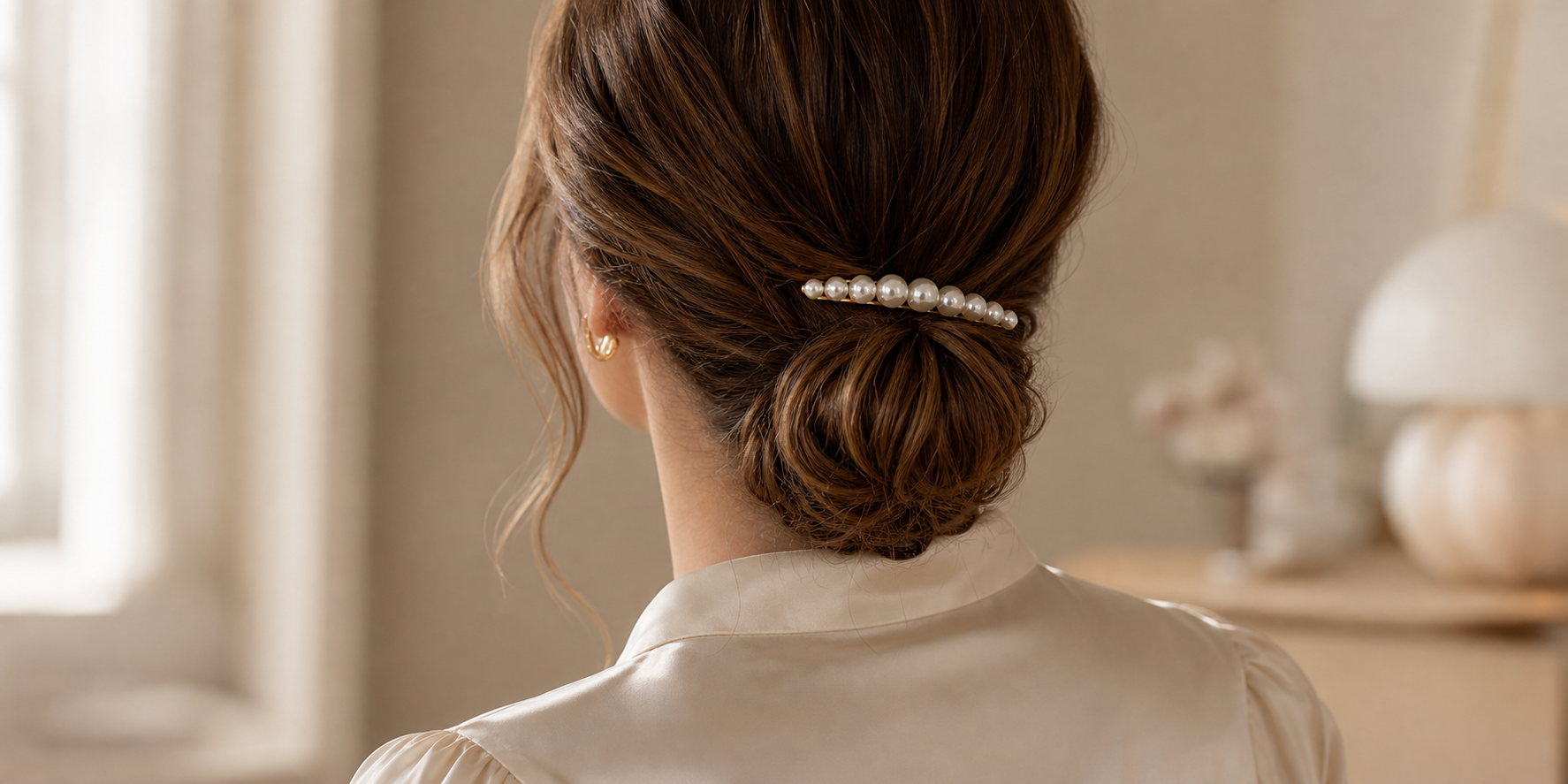 Low bun styled with a pearl barrette