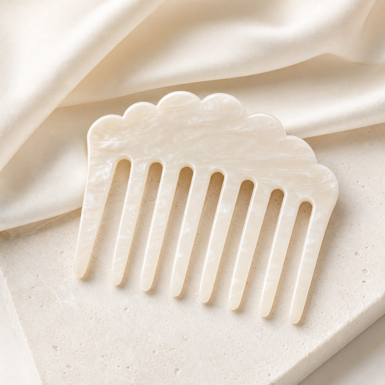 Ivory acetate hair comb on pale satin